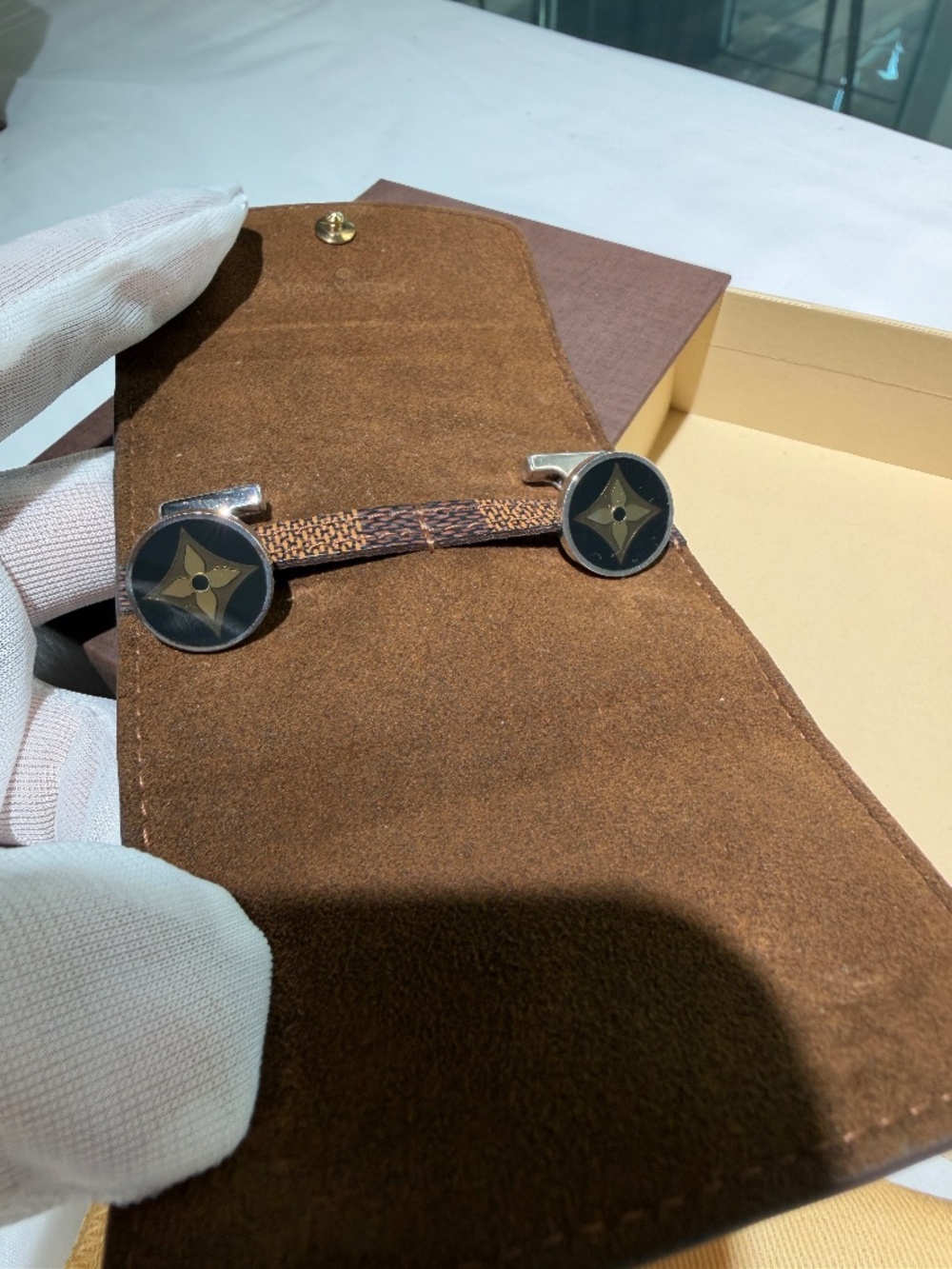 Louis Vuitton men cufflinks crafted in 925 silver with brown LV flower logo.